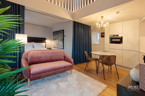 a hotel room with a bed and a table at ON/SET Alfama - Lisbon Cinema Apartments in Lisbon