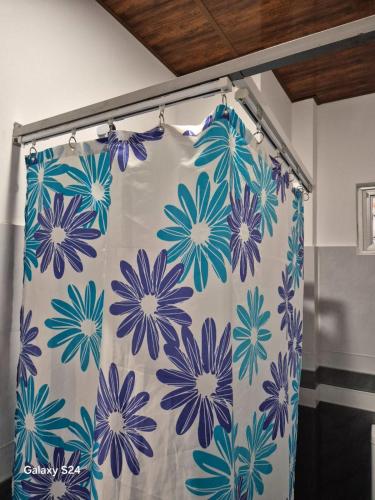 a shower curtain with blue flowers on it in a bathroom at STILLMOSS Ella in Ella