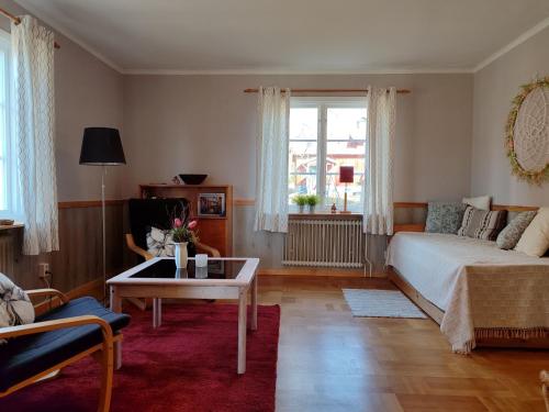 a living room with a bed and a coffee table at Näckros in Filipstad