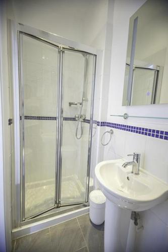 a bathroom with a shower and a sink at Oceanview in Woolacombe