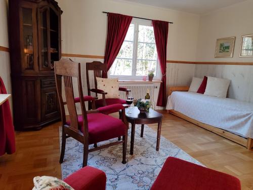 a bedroom with a bed and a chair and a table at Skogstjärna in Filipstad