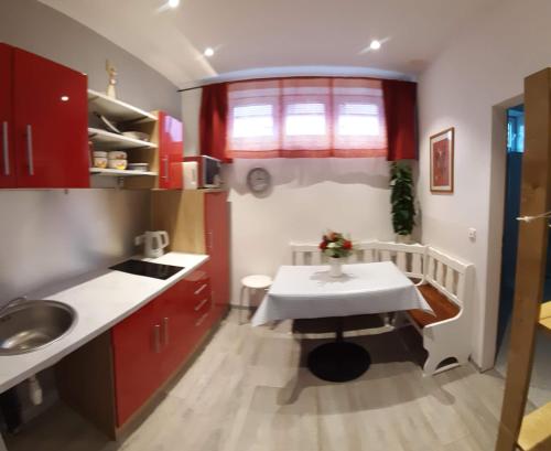 a small kitchen with a table and a sink at ApartmentHotel Vollumen in Redwitz an der Rodach