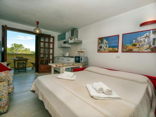 a bedroom with a bed with towels on it at Casa Gallo in Santa Marinella