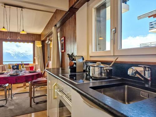 a kitchen with a sink and a counter top at Apartment App- 20A Ramuge by Interhome in Veysonnaz