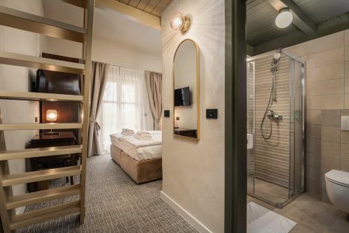 a bathroom with a bed and a shower and a toilet at Boutique Hotel Paradiso in Poreč