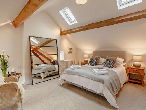 a bedroom with a large bed and a mirror at 2 Bed in Skipton oc-91296 in Bramley