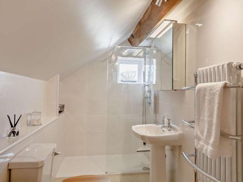 a white bathroom with a sink and a shower at 2 Bed in Skipton oc-91296 in Bramley