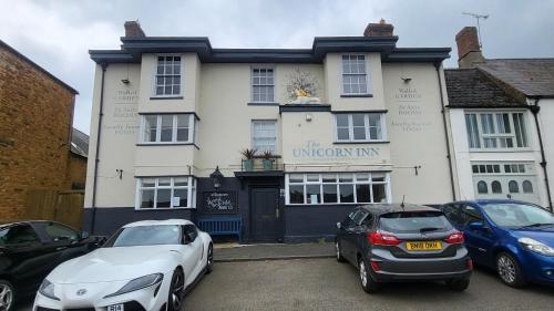 a building with cars parked in front of it at Unicorn Inn in Deddington