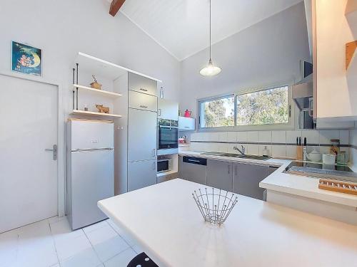a kitchen with a white counter and a refrigerator at Holiday Home Bernadon by Interhome in Labenne