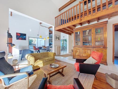 a living room with a couch and a table at Holiday Home Bernadon by Interhome in Labenne