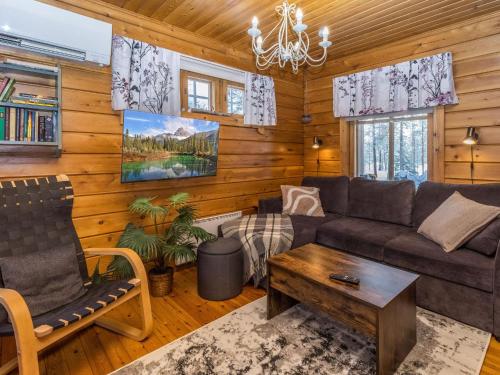 a living room with a couch and a table at Holiday Home Sallanrinne b by Interhome in Salla