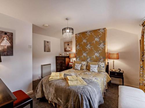 a bedroom with a bed and a chandelier at 2 Bed in Consett oc-91440 in Hunstanworth