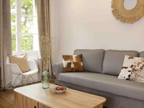 a living room with a couch and a coffee table at Paddock Prestige by La Boîte En Plus in Gouvieux