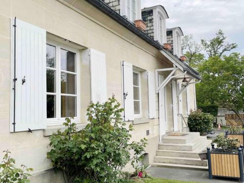 a white house with white windows and stairs at Paddock Prestige by La Boîte En Plus in Gouvieux
