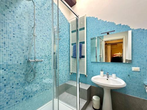 a bathroom with a glass shower and a sink at Galli Tassi Suite in Lucca