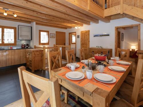 a dining room with a wooden table and chairs at Chalet Banksia by Interhome in Ovronnaz
