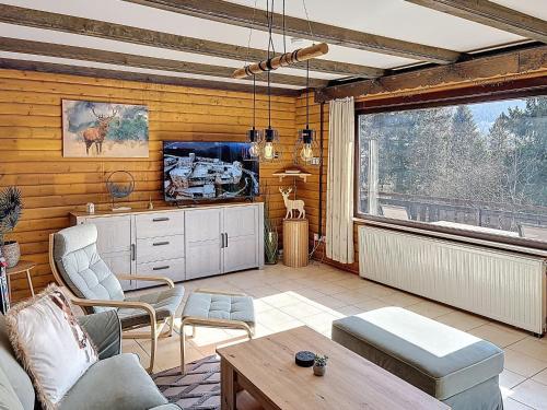 a living room with a couch and a tv at Apartment Franzi 2 by Interhome in Arrach