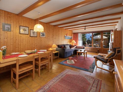 a living room with a table and a couch at Apartment Centaure B RI 1 by Interhome in Ovronnaz