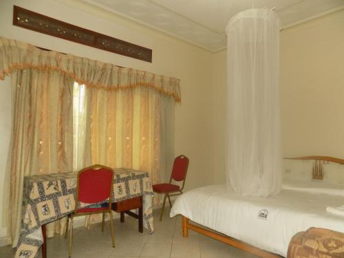 A bed or beds in a room at Rhino Motel Mbarara
