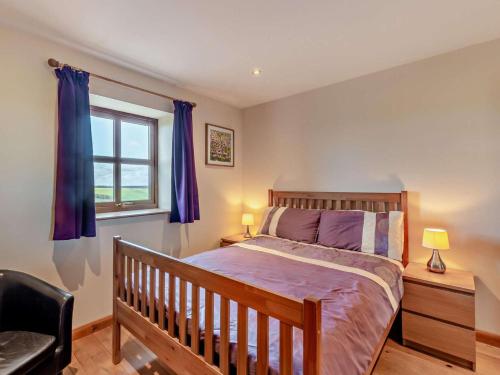 a bedroom with a wooden bed and a window at 3 Bed in Bishop Auckland oc-94320 in Wolsingham