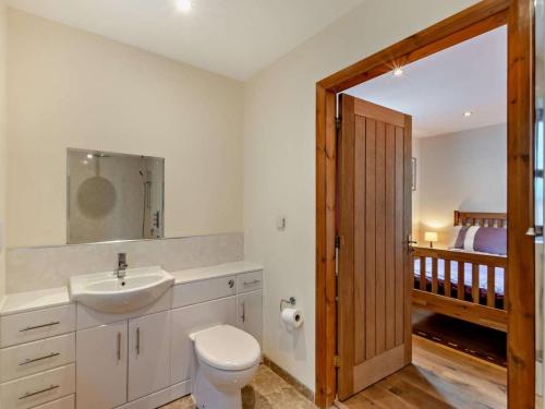 a bathroom with a white toilet and a sink at 3 Bed in Bishop Auckland oc-94320 in Wolsingham