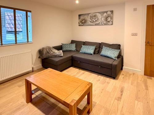 a living room with a couch and a coffee table at Broadweavers - Very Cute Cottage In Dursley By STAE-Homes in Gloucestershire