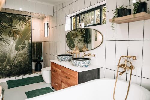 a bathroom with two sinks and a tub at Lagoon Haven House in Hermanus