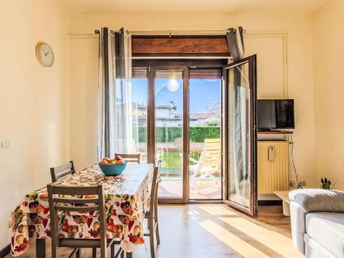 a dining room with a table and a sliding glass door at Apartment Casa Silvia by Interhome in Carlazzo