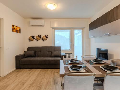 a living room with a table and a couch at Apartment Ilaria by Interhome in Riva del Garda