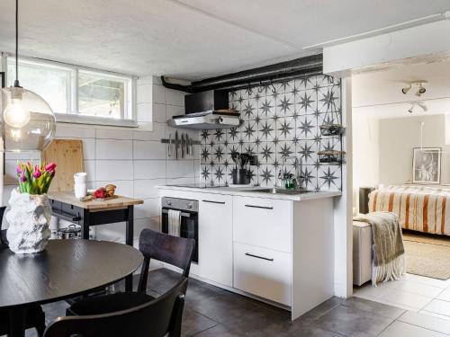 a kitchen with a table and a dining room at Apartment Vårhemsplatsen by Interhome in Halmstad