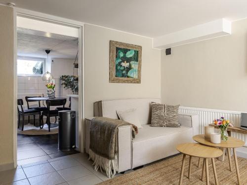 a living room with a couch and a table at Apartment Vårhemsplatsen by Interhome in Halmstad