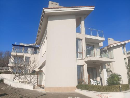a white building with a balcony on the side of it at Sun Village House 14 in Byala