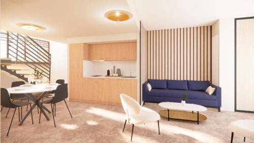 a living room with a blue couch and a table at Le VIBES RESORT By AGN "réservé aux couples" in Cap d'Agde