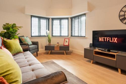 a living room with a couch and a television at City Centre perfect for exploring Chester in Chester