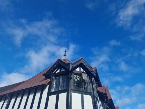 a building with a cross on the top of it at City Centre perfect for exploring Chester in Chester