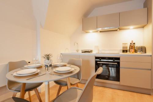 a kitchen with a table and chairs in a kitchen at City Centre perfect for exploring Chester in Chester