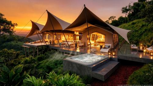 a luxury villa with a hot tub on a hill at Auralta Rio Celeste I Elohi Collection in Rio Celeste