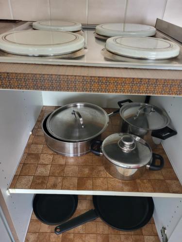 two pots and pans on a counter in a kitchen at Studio Residentie Astrid Bredene in Bredene