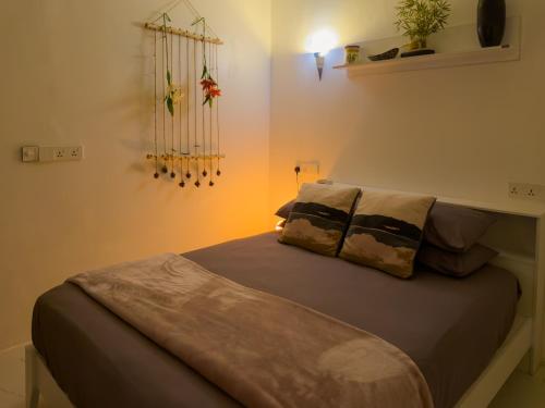 a bed with two pillows on it in a room at Diamond Stay Inn in Dhangethi
