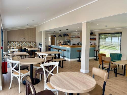 a restaurant with tables and chairs and a counter at Sunrise in Brixham