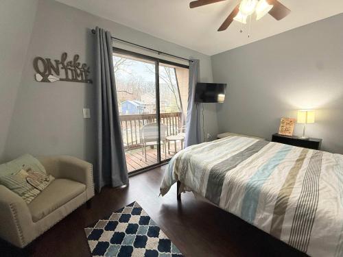a bedroom with a bed and a chair and a window at A Frame Escape Lake Access in Rocky Mount