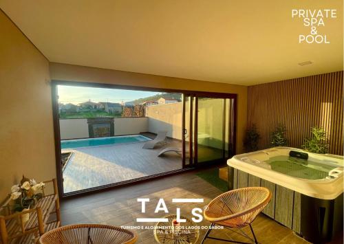 a room with a jacuzzi tub in the middle of a room at Turismo e Alojamento dos Lagos do Sabor - Piscina & SPA in Meirinhos
