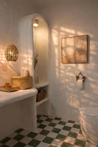 a bathroom with a sink and a checkered floor at AnB Garden in Ða Gia