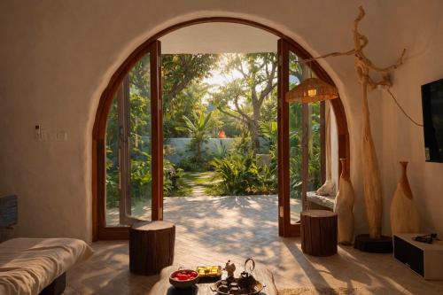 a room with an open door to a garden at AnB Garden in Ða Gia