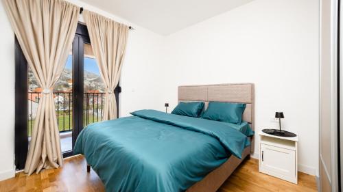 a bedroom with a bed and a large window at Royal View Cetinje in Cetinje