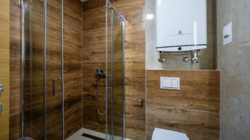 a bathroom with a shower with a glass door at Royal View Cetinje in Cetinje