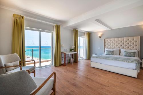 a bedroom with a bed and a view of the ocean at Vila Sao Vicente Boutique (Adults Only) in Albufeira