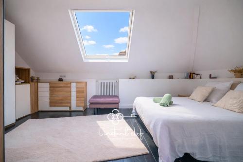 a bedroom with a large bed and a window at Villa élégante 5 chambres - 24H du Mans - Piscine Chauffée & Garage in Le Mans