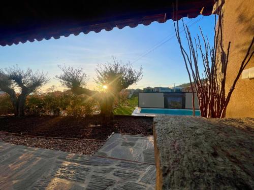 a view of the sun shining through the window of a house at Turismo e Alojamento dos Lagos do Sabor - Piscina & SPA in Meirinhos