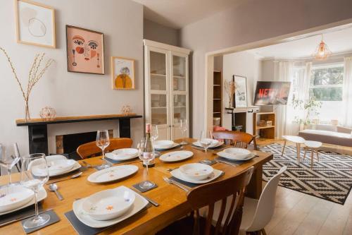 a dining room with a table with plates and wine glasses at Sleeps 6 off street parking close to city in Chester
